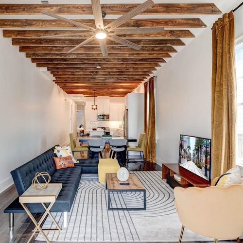 Soaring exposed wood beams give this historic home its unmistakable New Orleans soul.