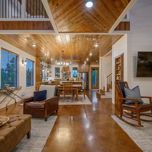 The living room seamlessly transitions into the dining area fand kitchen.