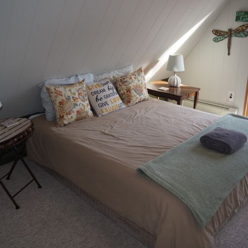 Bedroom #2 (second floor):  features a queen-size bed, walk-out balcony with lakeview, nightstands with lamps, ceiling fan, and a closet.