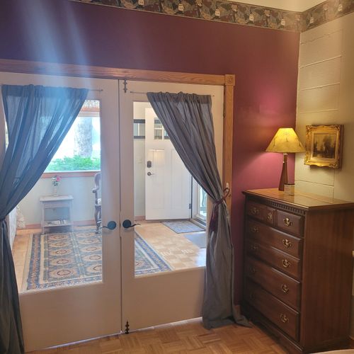 Bedroom #1 (main floor):  features a full-size bed, lots of shelving, a ceiling fan, and a dresser.