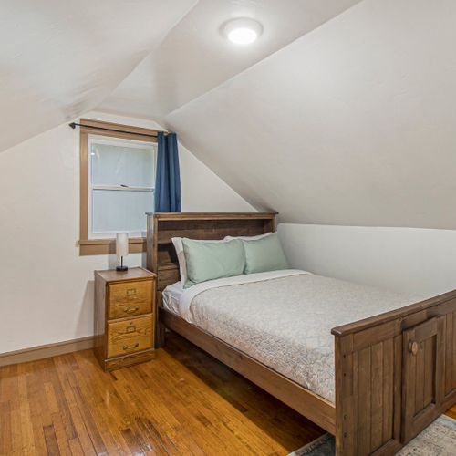 Serene bedroom with wood furnishings and cabin style.