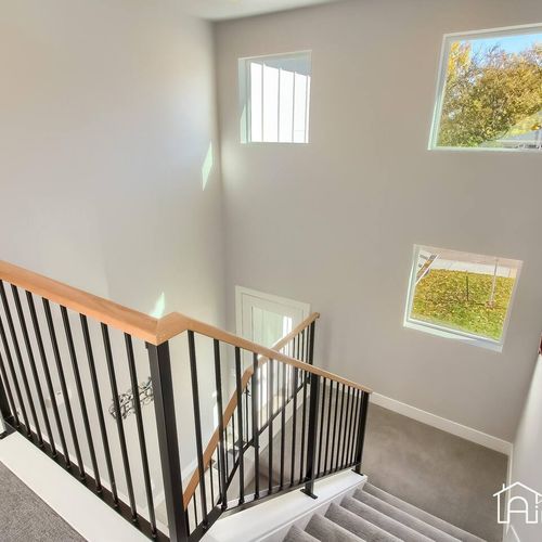 - sunlight floods the stairwell through three large windows that brighten the space
- sleek black railing and plush carpet lead you upstairs with style and comfort
- welcoming design element that connects all levels of the home
