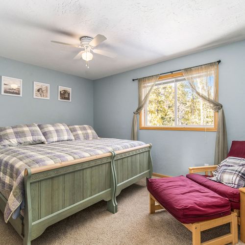 - relax in a serene bedroom featuring a comfy plaid king bed and soft blue walls