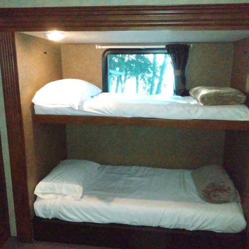 Bedroom #2:  includes 3 twin beds, a dresser, and a television.