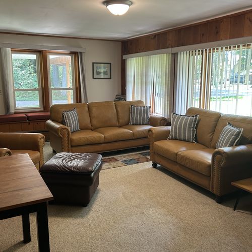 Living room: the cabin has a very cozy living room with a sofa, loveseat, comfy chair, and live streaming television.