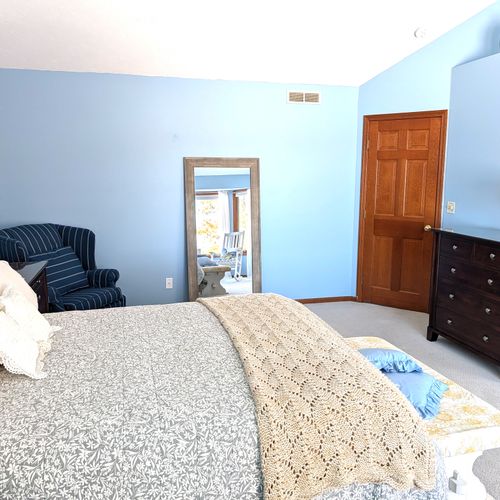 BEDROOM #2 (SECOND FLOOR):  The home has a huge primary bedroom on the second floor with a queen-size bed, private ensuite bathroom, and great views of Big Platte Lake!