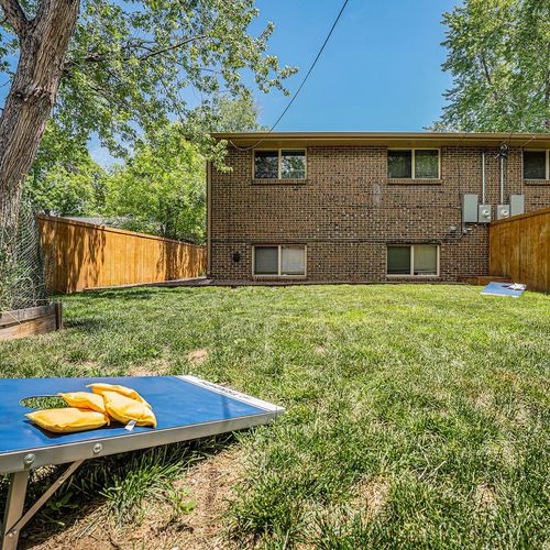 - large grassy yard offers space for fun and games including cornhole setup
- mature trees provide natural shade and fencing ensures total privacy
- ideal for family play pets lounging or lawn games under the colorado sky