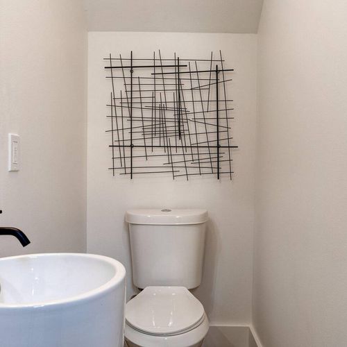 Chic half bath w/ modern fixtures & a sleek, stylish finish.