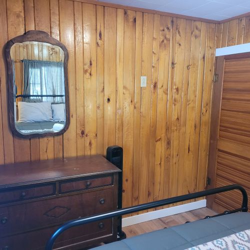 Bedroom #1:  features a queen-size bed, nightstands, lamps, a dresser, and a mirror.