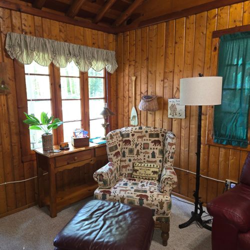 Living room:  the cabin has a very comfy and cozy living room with a sofa, comfy chair, gas fireplace, coffee table, and live streaming television with roku