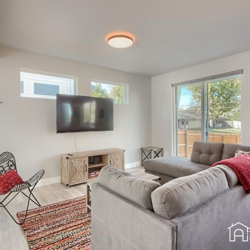 The living area is the perfect retreat after a long day! The comfortable furnishings and farmhouse interiors provide an inviting and cozy feel. The large windows let in plenty of natural light and provide a calm place to relax.