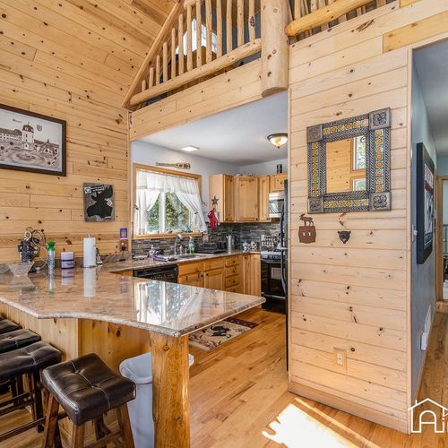 - pull up a stool and enjoy breakfast at the granite bar overlooking a warm, rustic kitchen
- vaulted pine walls and charming decor add a cozy alpine lodge feel to your mornings
- open layout makes cooking and gathering feel effortlessly connected