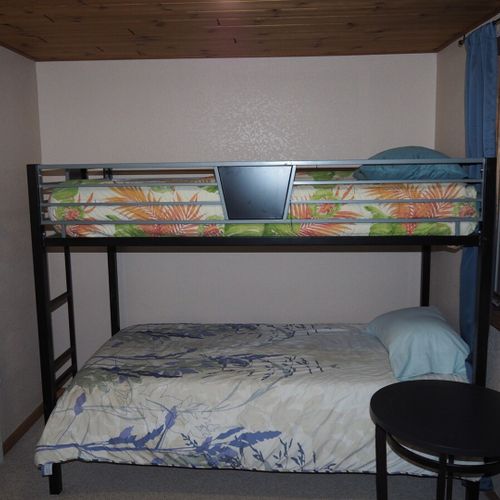 Bedroom #4 (upstairs):  features a twin-on-twin bunk bed, table, and a closet.