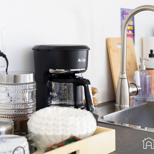 - wake up to fresh coffee with all the essentials at your fingertips
- coffee maker, sugar, stirrers, and mugs neatly arranged for easy morning routines
- stainless steel faucet and wooden accents add a polished touch to this compact setup