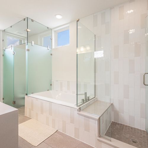 The expansive glass-door shower offers a calming, spa-like vibe with generous space to refresh.