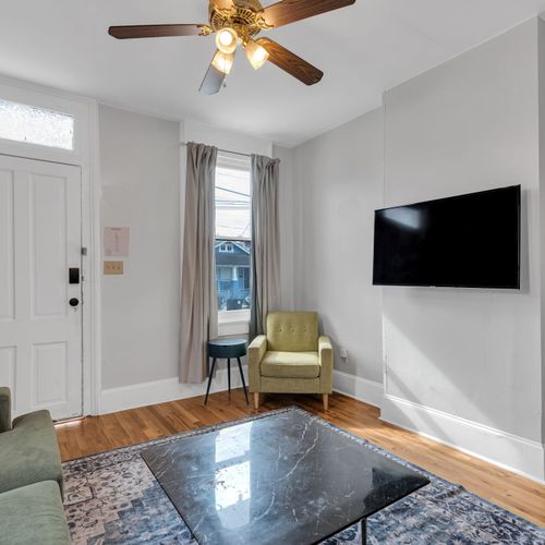 Relaxed living area w/ a wall-mounted smart TV for cozy nights in.