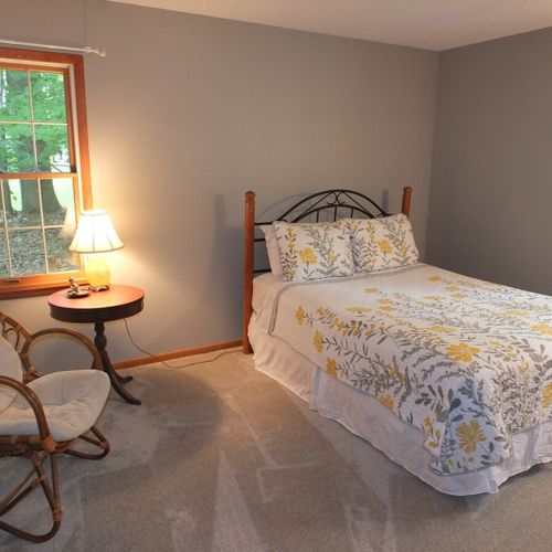 Bedroom #1:  features a queen-size bed, chair, nightstand, lamp, dresser, and 2 closets.