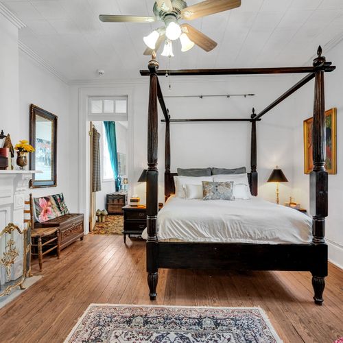 Spacious four-poster king bedroom w/ an airy, serene feel.