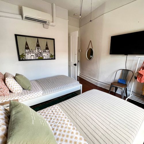 Bright, airy bedroom w/ a plush bed & clean, understated decor.