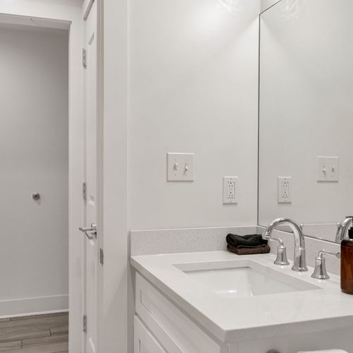 Bright vanity w/ sink & ample counter space to ease your morning routine.