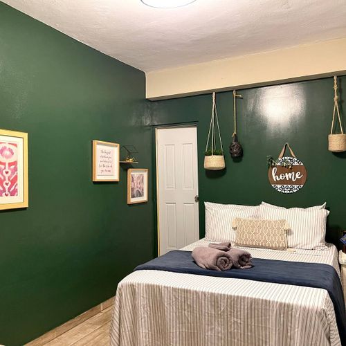A stylish main bedroom featuring a clean design and lush decor.