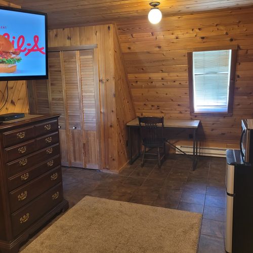 Bedroom #1 (main floor):  features a queen-size bed, private en suite bathroom, desk, dresser, mini-fridge, microwave, portable a/c unit, and its own private entrance.