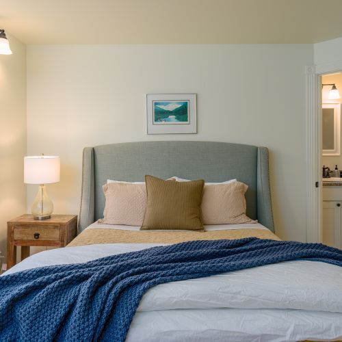 Inviting bedroom view with a comfortable bed, warm accents, and easy access to the private bathroom.