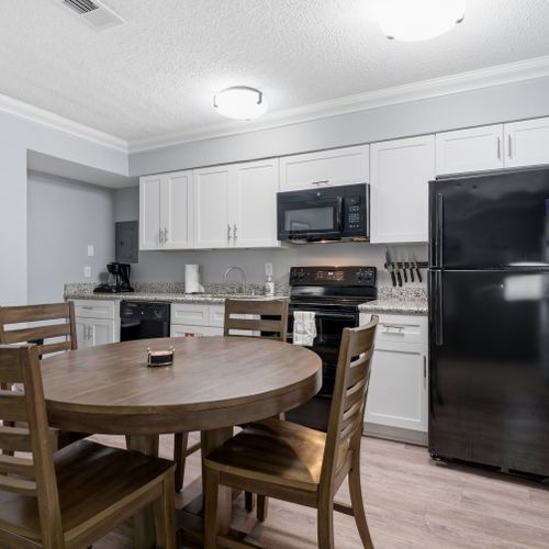 Modern kitchen w/ warm wood tones & full appliances.