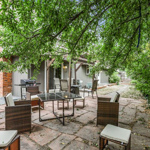 Step into the tranquil backyard, complete with cozy seating and outdoor dining set. Please note the pergola has been removed and patio furniture may be put into storage during the winter months.