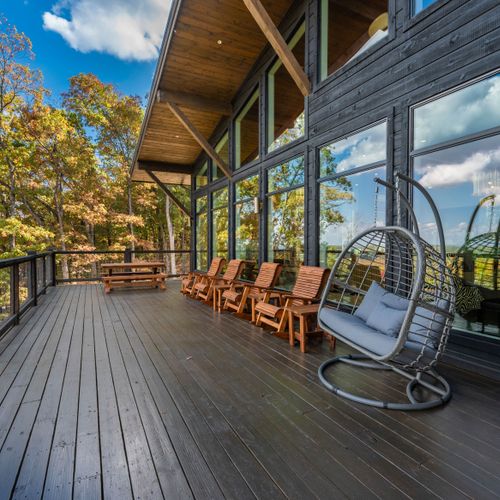 Spacious terrace with comfy swing, chairs and dining area.