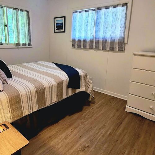 Bedroom #2:  bedroom #2 features a full-size bed, closet, dresser, and nightstands with lamps.