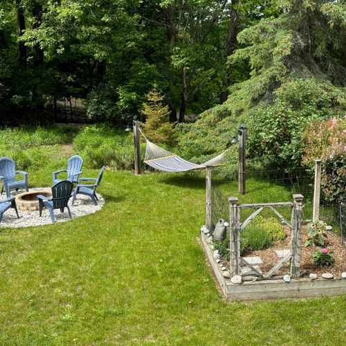 Exterior:  the gorgeous backyard with fire pit, hammock, and herb garden