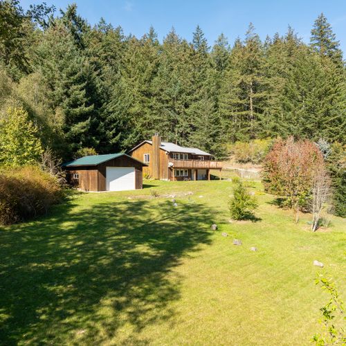 Expansive lawns and flowers beds make this a unique island home.