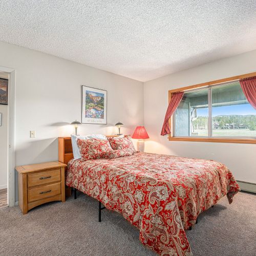 Wake up to serene forest views from the master bedroom window.