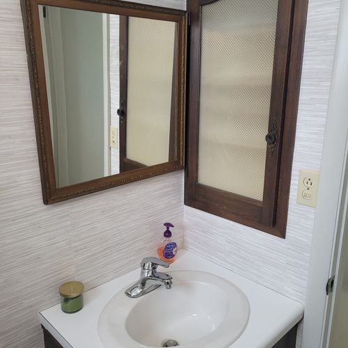 Bathroom #2:  cute little half-bathroom with toilet, sink, vanity, and mirror located near the rear door out to the deck.