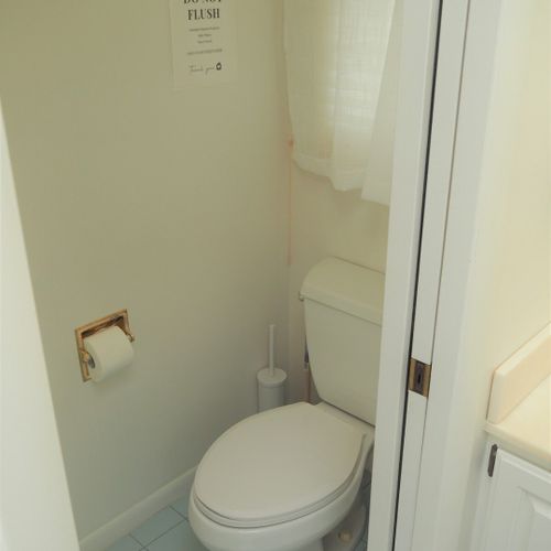 Bathroom #2 (main floor):  this is a private en suite bathroom for the master bedroom (bedroom #1). Features 2 sinks, a large bathtub, and separate shower and toilet facilities.