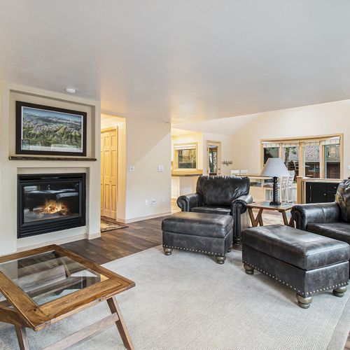Snuggle up in this living room with a firepit and comfy seating.