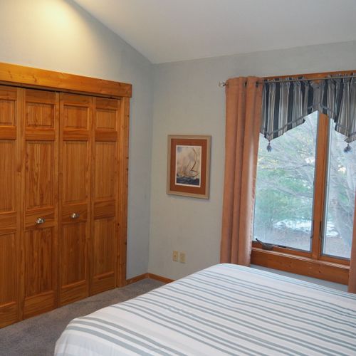 Bedroom #2 (second floor):  features a queen-size bed, desk with chair, mirror, and a large closet.