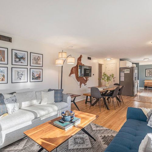 - open layout connects the bright living area with a sleek dining nook and modern kitchen
- light hardwood floors and bold artwork give the space a polished yet warm feel
- ideal for entertaining or spending time together as a group