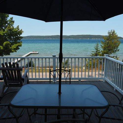 Exterior:  the dining table on the deck with the lake in the background.