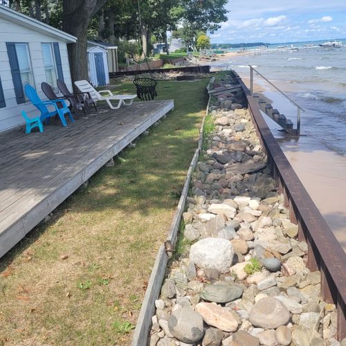 Exterior:  the private deck, beach, fire pit, and lakefront at the beach house.