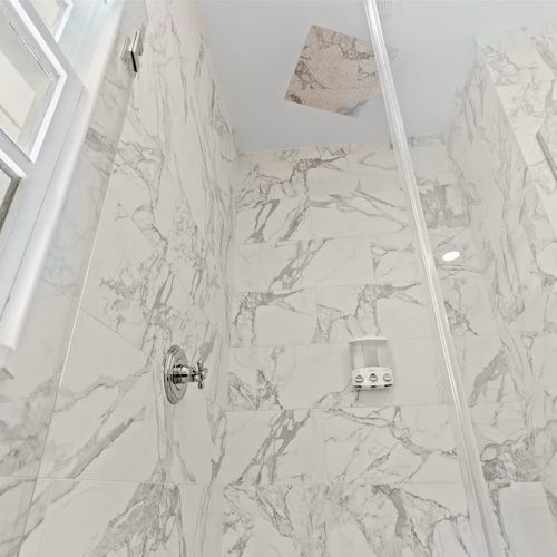 Elegant marble-look tile detail adding a luxe touch to the bathroom.