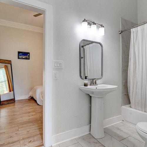 Bathroom vanity w/ sink & mirror — functional & neatly designed for your daily routine.