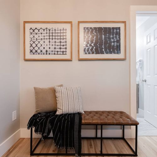 - unwind in this quiet corner featuring a cushioned bench and soft throw pillows
- artistic prints and natural light create a calming vibe near the ensuite
- great spot to relax with a book or drop your bag after a day out