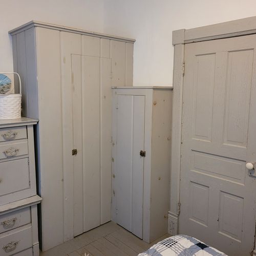 BEDROOM #1 (MAIN FLOOR):  Features a queen-size bed, nightstands, a dresser, mirror, and closet.