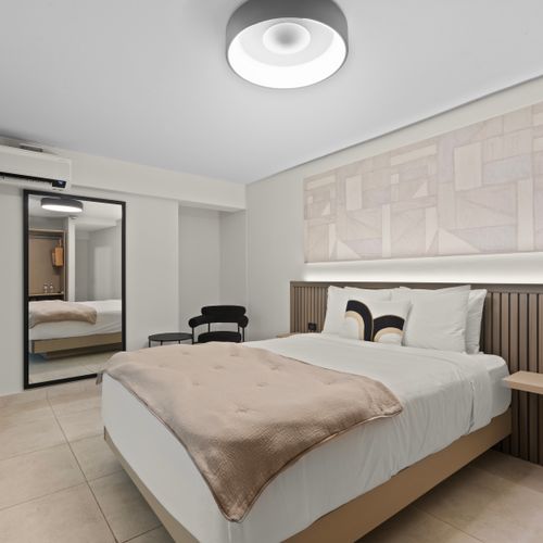 A vintage-inspired bedroom with large mirror.