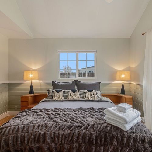 - drift off under cozy layers with twin lamps casting a dreamy golden glow
- wake up to sunshine through dual windows and a peaceful neighborhood view
- modern texture meets mid century flair for a space that feels effortlessly cool