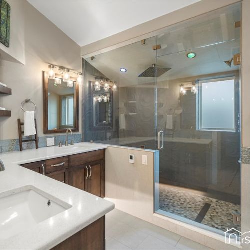 This large bathroom features heated floors and kohler steam shower system.