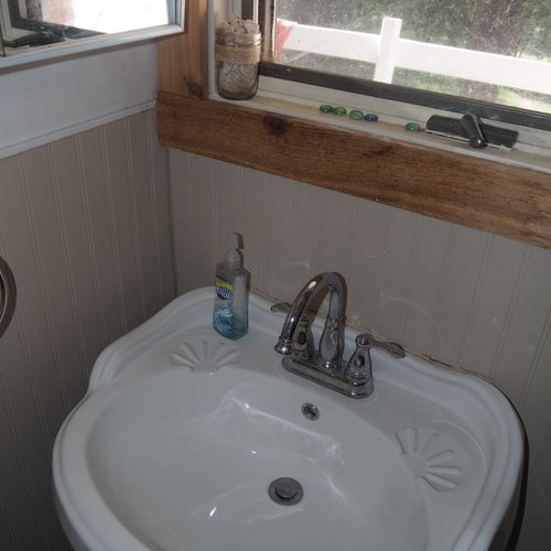 Bathroom:  small, but full bathroom, with entrance from the living room. Includes sink, mirror, toilet, and shower.