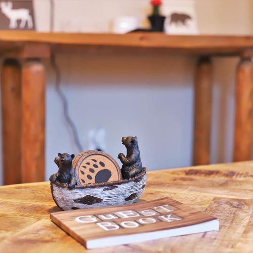 - thoughtful bear themed touches bring charm to every corner of this retreat
- unique coasters and guidebook add both character and convenience for guests
- coffee table centerpiece highlights the playful wilderness spirit throughout